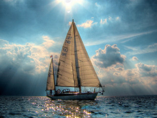 Sailboat ocean cloudy sky sunbeams - the ocean under a cloudy sky free wallpaper