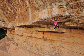 Woman climbing cliff rock face - the cliff free wallpaper