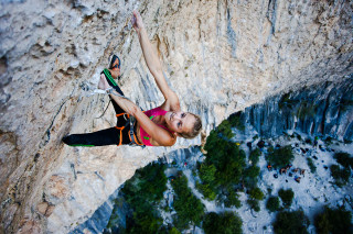 Woman climbing steep cliff rope - a rope free wallpaper