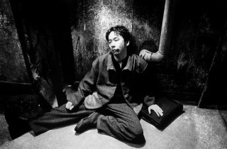 Man sitting ground hands pockets - his mouth free wallpaper