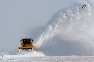 Snow blower spraying snow field - the side free wallpaper