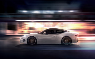 White sports car night motion - a cityscape in the background free wallpaper