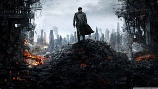 Man standing rubble city sky - top of a pile free wallpaper