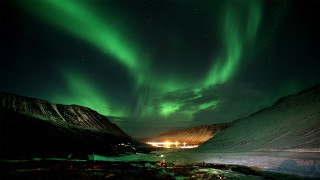 Green aurora mountains night city - the sky above a mountain range free wallpaper