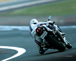 Person motorcycle race track helmet - dynamic camera angle free wallpaper