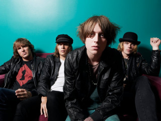 Group men couch blue wall - top of a couch next free wallpaper