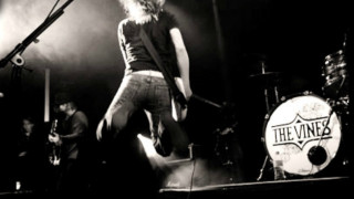 Man standing stage guitar microphone - a guitar in front free wallpaper