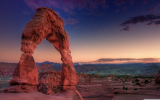 Large rock formation desert sunset - a large rock formation in the middle of a desert area free wallpaper
