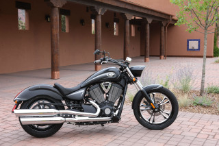 Motorcycle parked brick sidewalk building - a clock free wallpaper