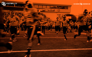 Football players running field crowd - dan frazier free wallpaper