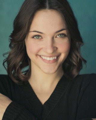 Smiling woman arms crossed black - a black sweater free wallpaper