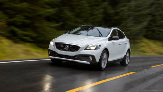 White volvo car driving road - a rainy day free wallpaper