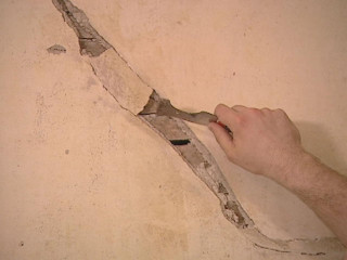 Man cutting hole wall plasterboard - the fifth element artifact free wallpaper