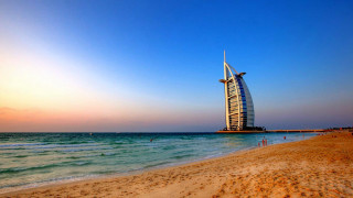 Tall building sandy beach ocean 2 - a sandy beach next free wallpaper