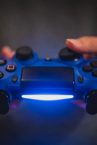 Person holding blue controller light - a black background behind free wallpaper for mobile