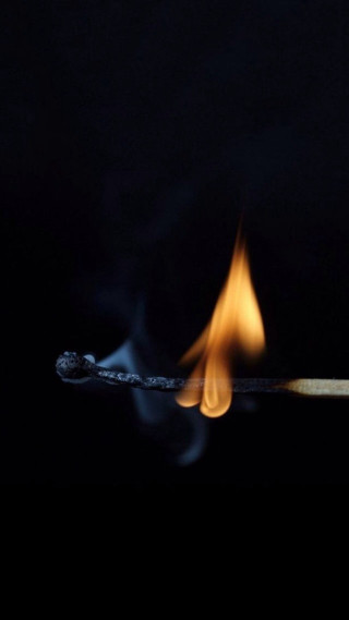 Matchstick lit flame dark lighting - a macro photograph free wallpaper for mobile