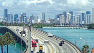 Highway traffic city tall buildings - a highway free wallpaper