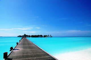 Pier beach blue sky water - a small island in the distance free wallpaper