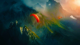 Man paragliding mountain sky parachute - a mountain range in the background free wallpaper