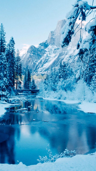 Snowy mountain landscape lake trees - free winter wallpaper for mobile