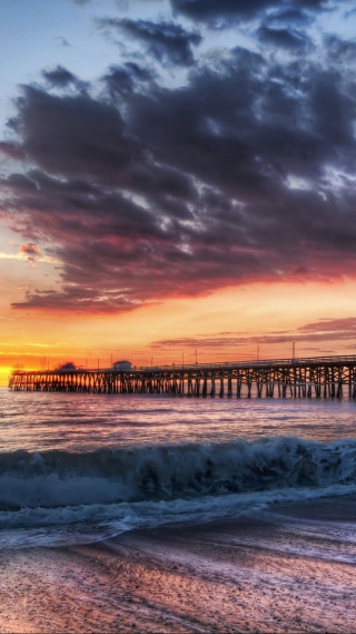 Pier sunset waves orange sky - free sunset wallpaper for mobile