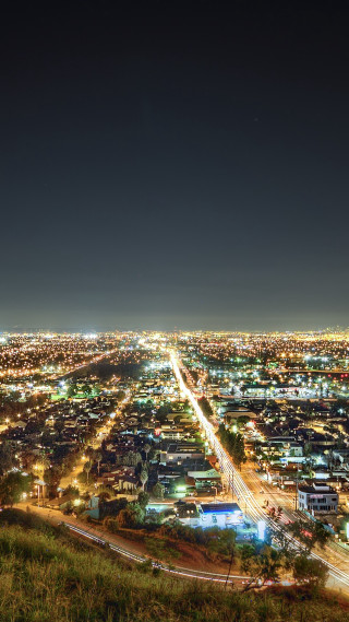 City night lights hill grassy - free city wallpaper for mobile