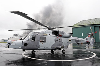 Helicopter parked wet runway smoke - a helicopter free wallpaper