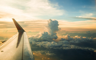 Plane wing sunset clouds lake - liminal free wallpaper