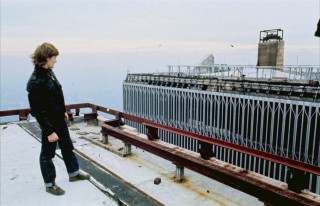 Man standing building fence metal - top of a building next free wallpaper