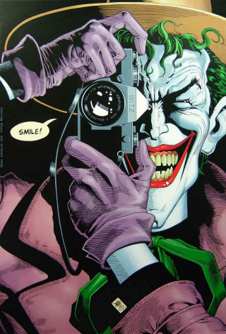 Joker holding camera pointing smiling - a camera free wallpaper for mobile