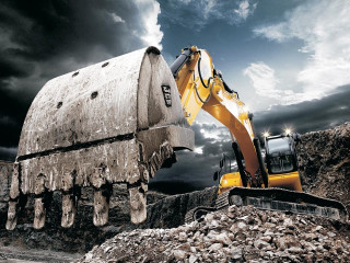 Bulldozer digging rocks cloudy sky - hard surface free wallpaper