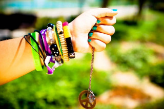 Woman holding bracelets peace sign - her wrist free wallpaper
