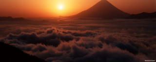 Sunset mountains clouds volumetric light - cloud below free wallpaper
