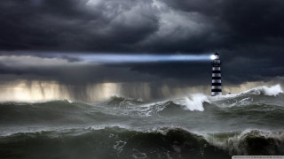 Lighthouse storm light beam ocean - stormy weather free wallpaper