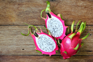 Dragon fruit halves wooden table - other fruit free wallpaper