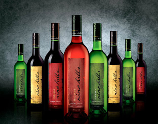 Wine bottles table black background - rich color free wallpaper