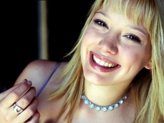 Woman necklace ring smiling camera - her face and a necklace free wallpaper