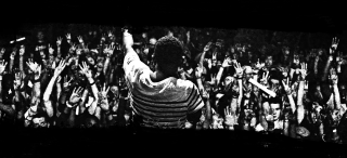 Man standing crowd stage arms - cinematic free wallpaper