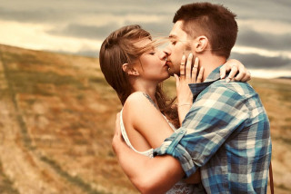 Man woman kissing field cloudy - romantic free wallpaper