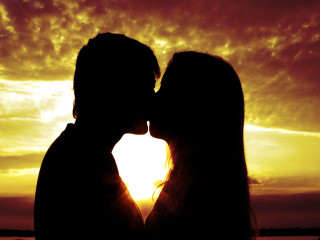 Couple kissing sunset sky clouds - romantic free wallpaper
