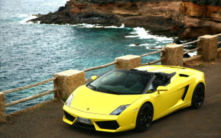 Yellow sports car ocean cliff 2 - a rock formation free wallpaper
