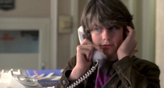 Young boy phone serious look - a young boy free wallpaper