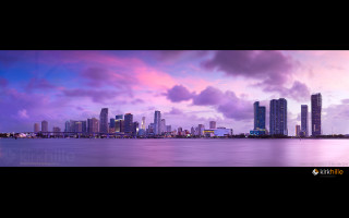 City skyline purple sky water - a purple sky and water free wallpaper
