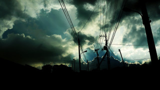 Dark sky clouds power lines - a sunbeam free wallpaper