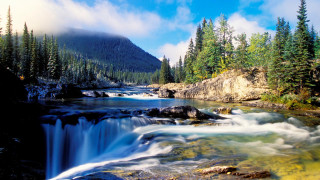 River waterfall trees mountains bridge - the foreground and a mountain in the background free wallpaper