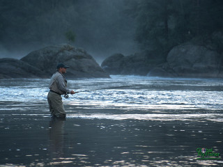 Man standing water holding fish - river free wallpaper for desktop