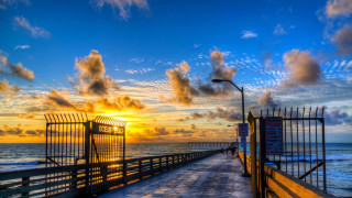 Pier fence sunset ocean cityscape - colorful cloud free wallpaper