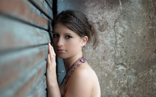 Woman leaning brick wall hand - her cheek free wallpaper