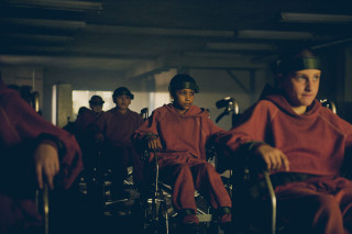 Group people sitting chairs room - a wall behind them free wallpaper