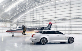 White car parked jet hangar - the ground behind free wallpaper